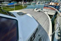 1990 Trader 41 + 2 Sundeck yacht with spacious deck, docked in a marina.
