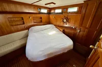 Cozy cabin interior of 1990 Trader 41 + 2 Sundeck yacht with wooden finish.