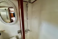 Bathroom interior of 1990 Trader 41 + 2 Sundeck yacht with shower and mirror.