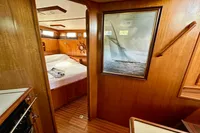 Interior of 1990 Trader 41 + 2 Sundeck yacht with wood paneling and nautical decor.