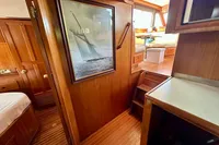 Interior of 1990 Trader 41 + 2 Sundeck yacht with wooden paneling and nautical decor.
