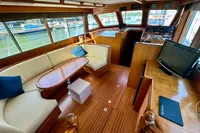 Luxurious interior of 1990 Trader 41 + 2 Sundeck yacht with elegant seating and navigation area.
