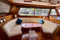 Luxurious 1990 Trader 41 + 2 Sundeck yacht interior with elegant seating and wooden finishes.