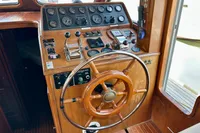 1990 Trader 41 + 2 Sundeck helm with wooden wheel and control panel.
