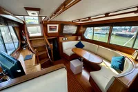 Interior of 1990 Trader 41 + 2 Sundeck yacht with wood finish and seating area.