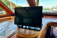 1990 Trader 41 + 2 Sundeck boat interior with navigation screen on wooden dashboard.