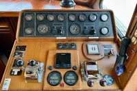 Cockpit controls of a 1990 Trader 41 + 2 Sundeck yacht, featuring gauges and navigation equipment.