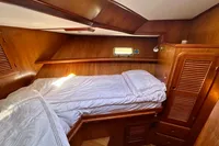Cozy cabin interior of 1990 Trader 41 + 2 Sundeck yacht with wooden finish.