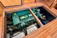 Engine compartment of 1990 Trader 41 + 2 Sundeck yacht, showcasing a green marine engine.