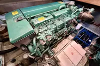 Engine room of 1990 Trader 41 + 2 Sundeck yacht, featuring a green marine engine.
