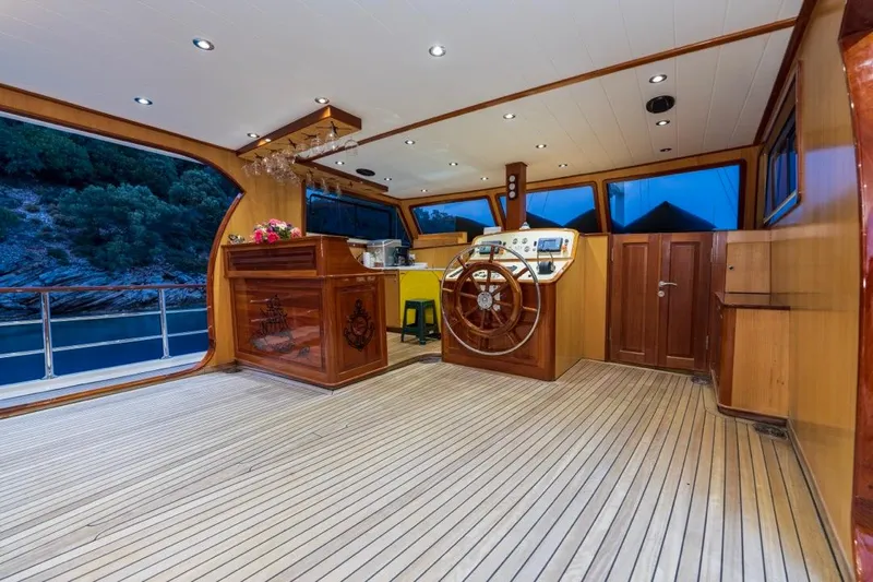  Yacht Photos Pics Luxurious 2022 Gulet 24m yacht interior with wooden helm and elegant bar area.