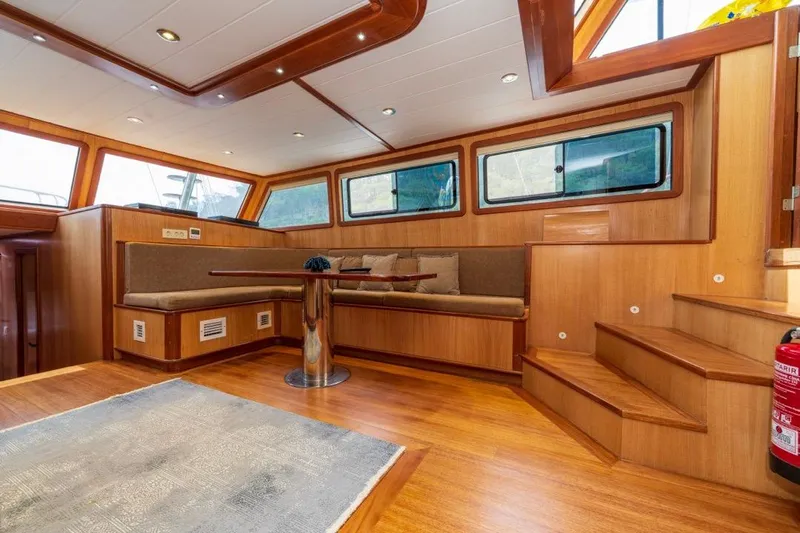  Yacht Photos Pics Luxurious 2022 Gulet 24m yacht interior with wooden finishes and cozy seating area.