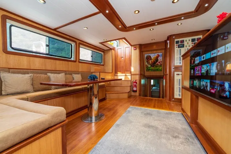  Yacht Photos Pics Luxurious 2022 Gulet 24m yacht interior with plush seating, modern decor, and entertainment system.