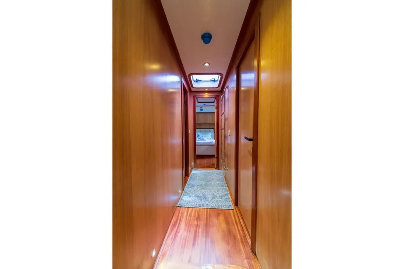  Yacht Photos Pics Luxurious wooden hallway interior of 2022 Gulet 24m yacht, featuring elegant design and modern lighting.