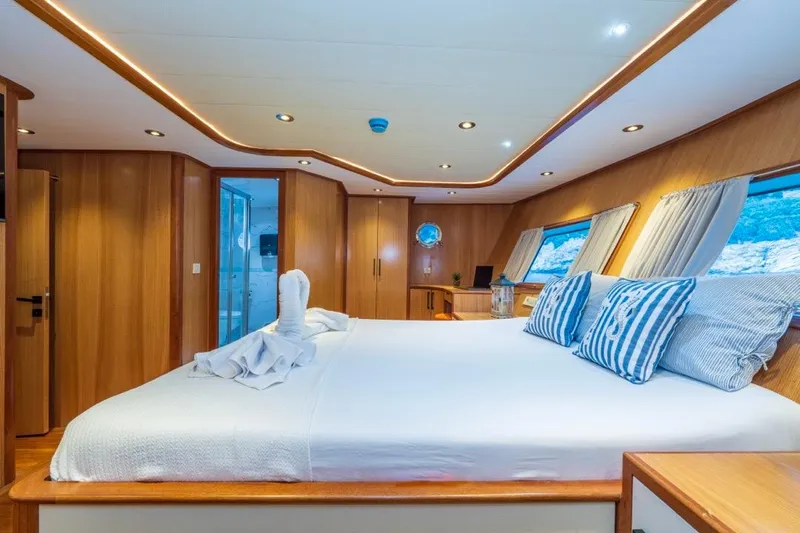  Yacht Photos Pics Luxurious 2022 Gulet 24m yacht cabin with elegant wood interior and scenic windows.