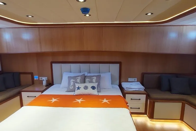  Yacht Photos Pics Luxurious cabin interior of 2022 Gulet 24 m yacht with cozy bed and seating.