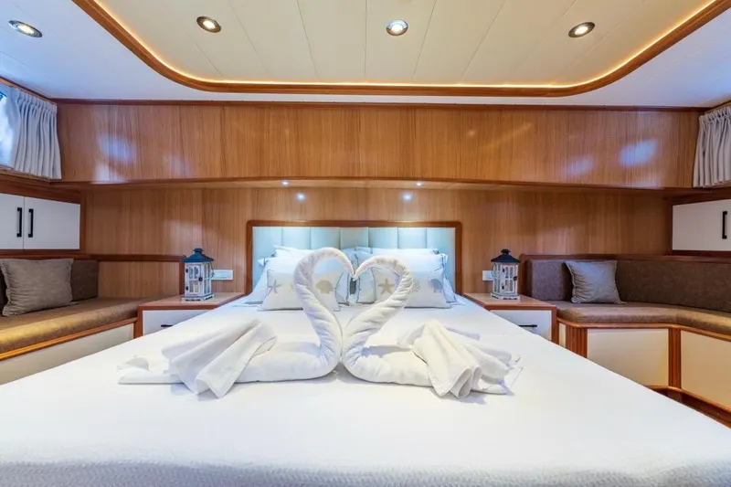  Yacht Photos Pics Luxurious Gulet 24m 2022 yacht cabin with elegant swan towel art on bed.