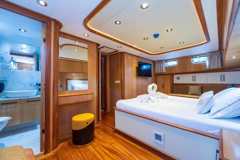  Yacht Photos Pics Luxurious 2022 Gulet 24m yacht cabin with elegant wood finish and modern amenities.