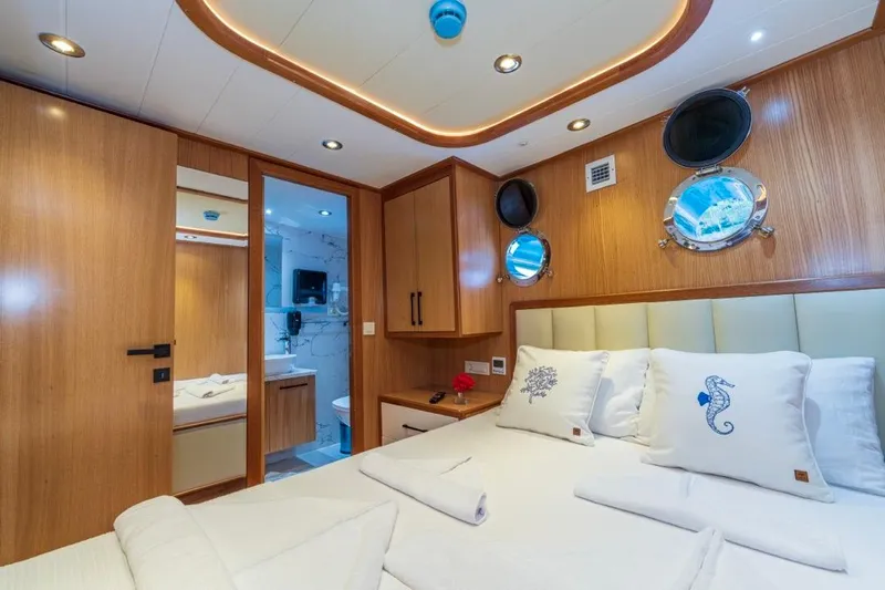 Yacht Photos Pics Luxurious Gulet 24m yacht cabin with elegant wood finish and modern amenities, 2022 model.
