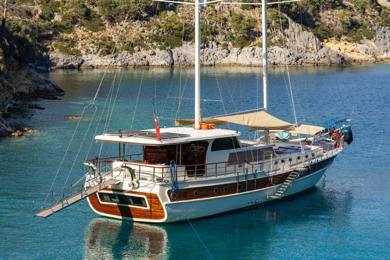  Yacht Photos Pics Luxurious 2022 Gulet 24m yacht anchored in a serene, picturesque bay.