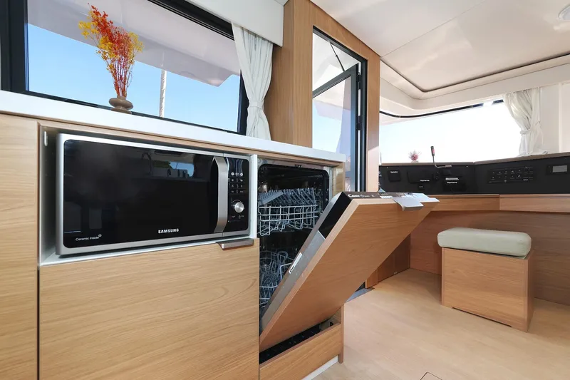 Belle Amie Yacht Photos Pics Modern kitchen interior on Bali 4.6 yacht, featuring a microwave and open dishwasher, 2025 model.