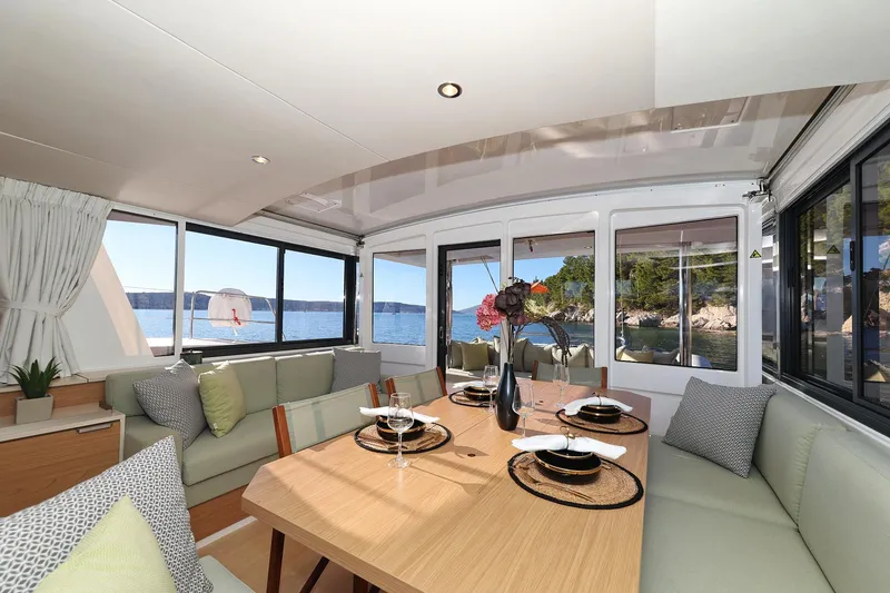 Belle Amie Yacht Photos Pics Luxurious interior of 2025 Bali 4.6 yacht with elegant dining setup and scenic ocean view.