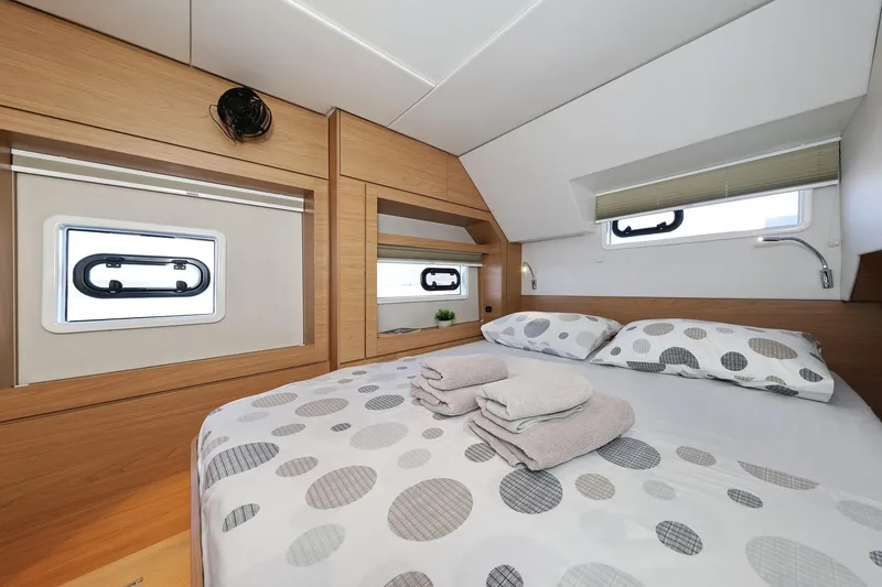 Belle Amie Yacht Photos Pics Luxurious cabin interior of 2025 Bali 4.6 yacht with cozy bedding and modern design.