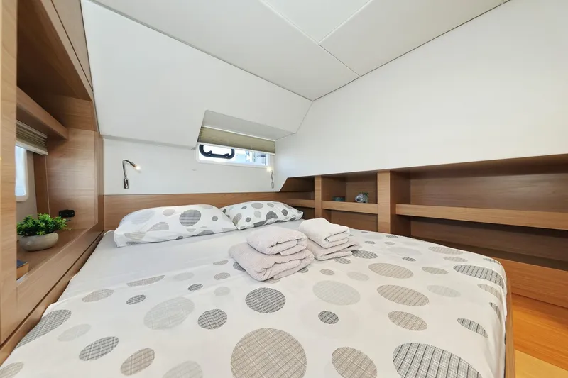 Belle Amie Yacht Photos Pics Luxurious cabin interior of 2025 Bali 4.6 yacht with cozy bedding and modern design.