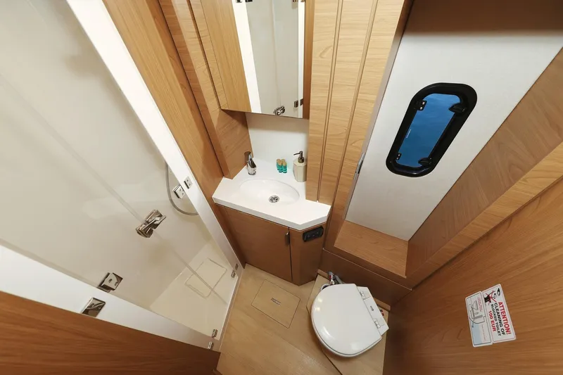 Belle Amie Yacht Photos Pics Modern bathroom interior in 2025 Bali 4.6 model yacht, featuring wood accents and compact design.
