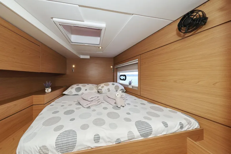 Belle Amie Yacht Photos Pics Cozy bedroom in 2025 Bali 4.6 yacht with modern wood paneling and skylight.