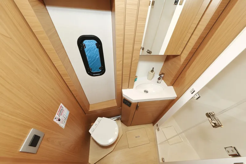 Belle Amie Yacht Photos Pics Modern bathroom in 2025 Bali 4.6 yacht with wood accents and compact design.