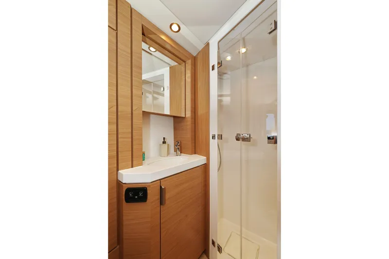 Belle Amie Yacht Photos Pics Modern yacht bathroom with wood accents, glass shower, and sleek fixtures in Bali 4.6, 2025 model.