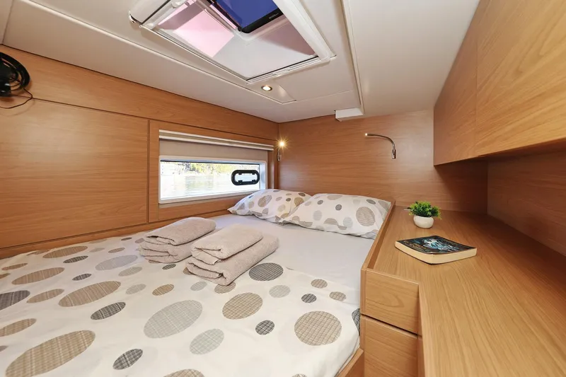 Belle Amie Yacht Photos Pics Cozy cabin interior of 2025 Bali 4.6 yacht with bed and skylight.