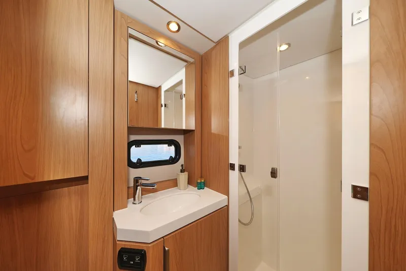 Belle Amie Yacht Photos Pics Modern bathroom in 2025 Bali 4.6 yacht with wood accents and sleek fixtures.