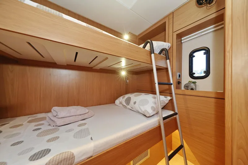 Belle Amie Yacht Photos Pics Bali 4.6 2025 yacht interior with wooden bunk beds and ladder.