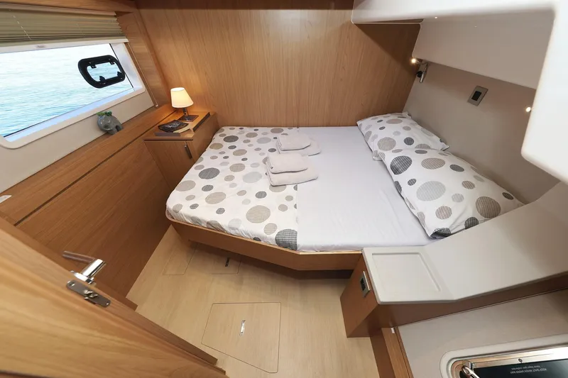 Belle Amie Yacht Photos Pics Cozy cabin interior of 2025 Bali 4.6 yacht with modern wooden design and comfortable bedding.