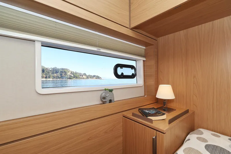 Belle Amie Yacht Photos Pics Cozy cabin interior of 2025 Bali 4.6 yacht with scenic window view.