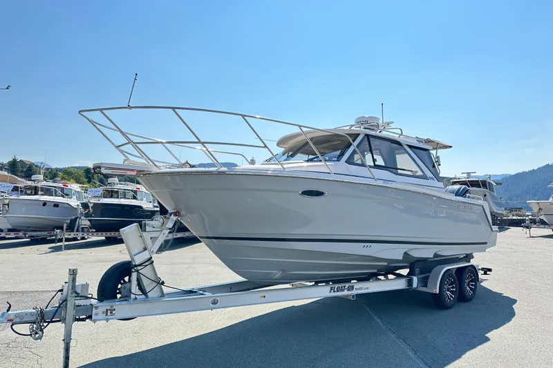  Yacht Photos Pics 2026 Cutwater C-248 Coupe boat on trailer under clear blue sky.