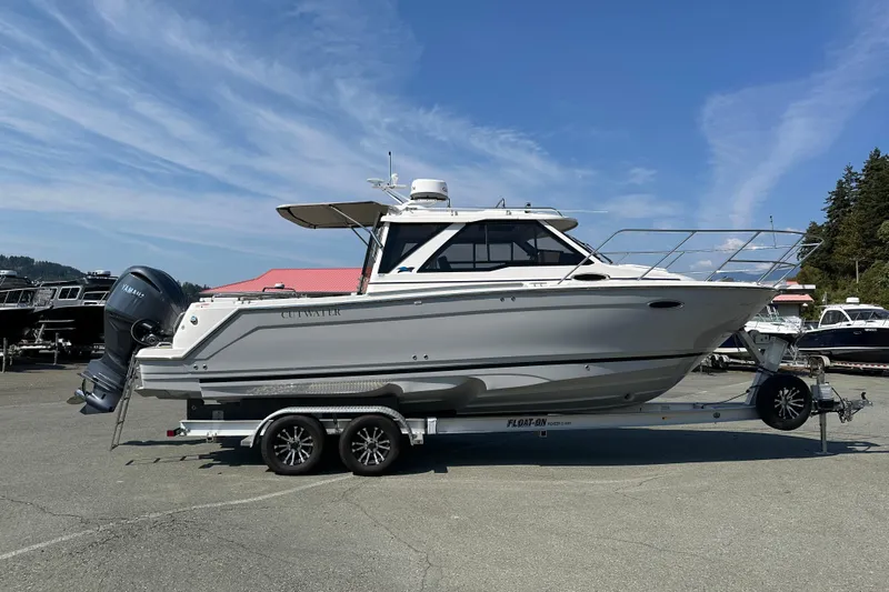  Yacht Photos Pics 2026 Cutwater C-248 Coupe boat on trailer under clear blue sky.
