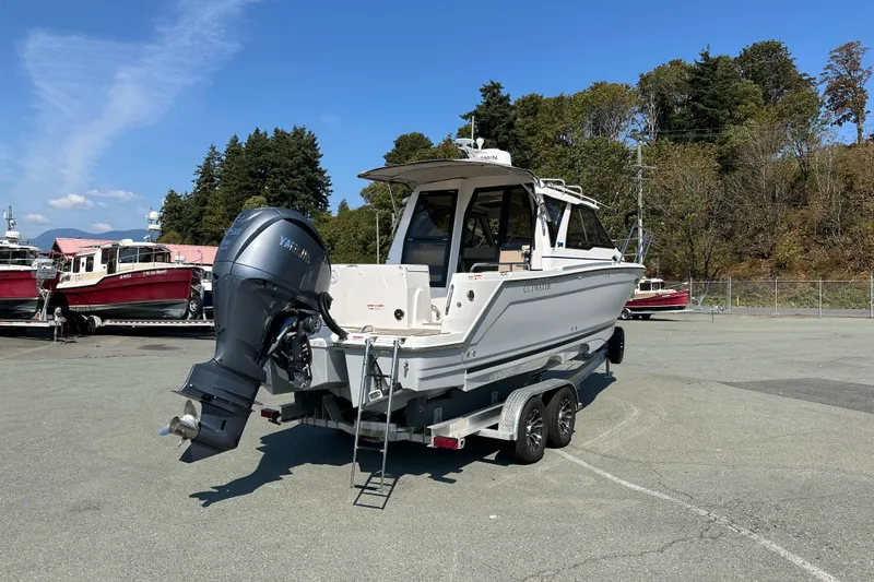  Yacht Photos Pics 2026 Cutwater C-248 Coupe boat on trailer, parked outdoors under clear sky.