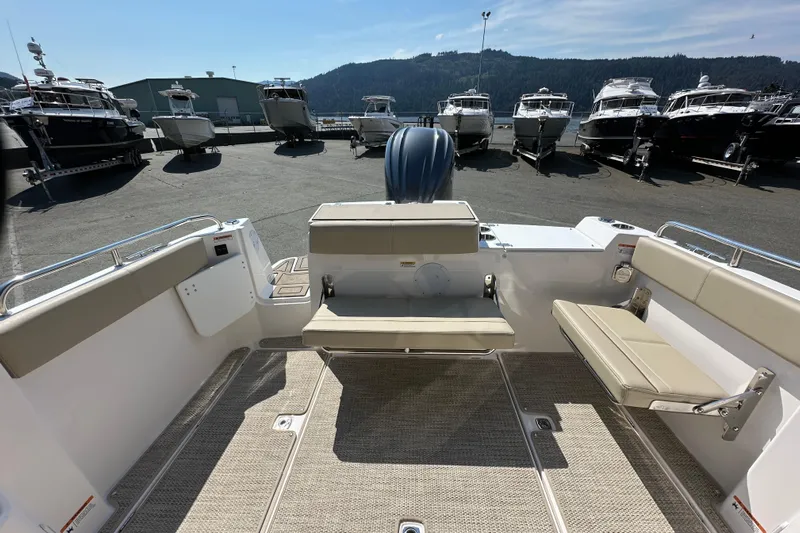  Yacht Photos Pics 2026 Cutwater C-248 Coupe boat interior with seating, docked among other boats.
