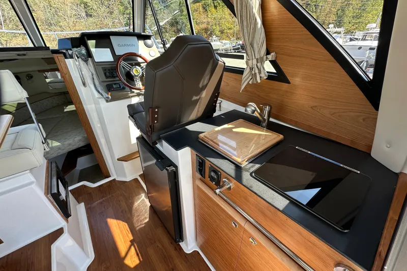  Yacht Photos Pics 2026 Cutwater C-248 Coupe interior with helm, kitchenette, and modern amenities.