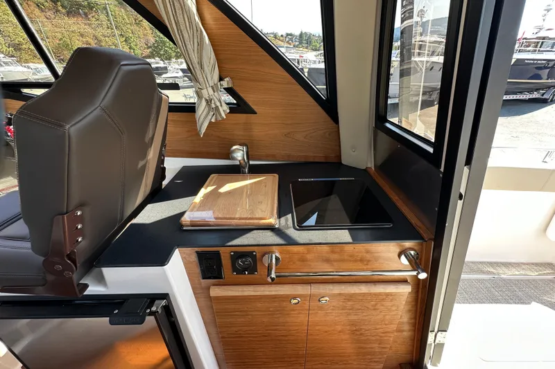  Yacht Photos Pics 2026 Cutwater C-248 Coupe interior with modern kitchenette and sleek design.
