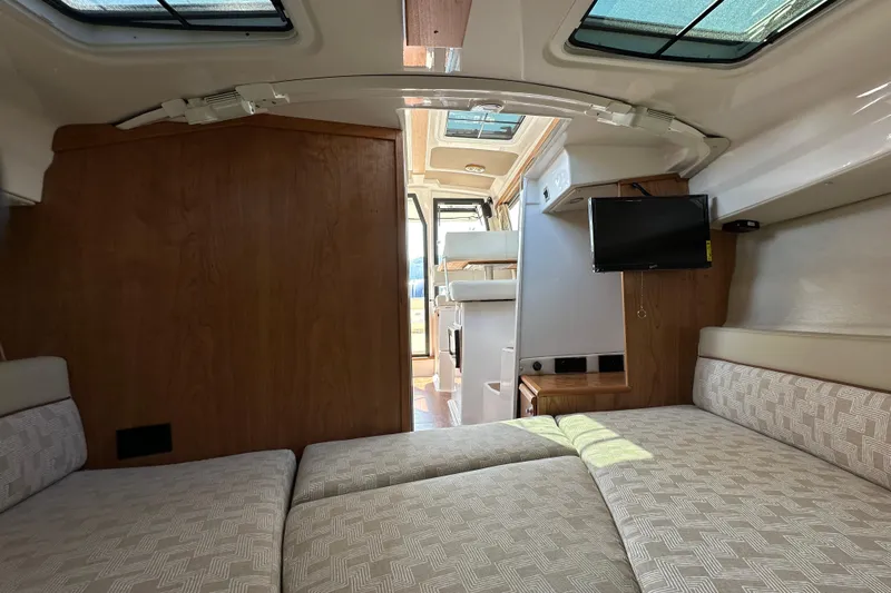  Yacht Photos Pics Interior of 2026 Cutwater C-248 Coupe, featuring cozy seating and a mounted TV.