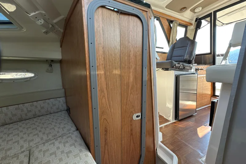  Yacht Photos Pics Interior of 2026 Cutwater C-248 Coupe, featuring cabin seating and helm area.