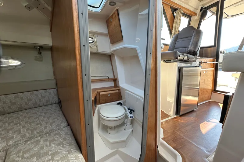 Yacht Photos Pics 2026 Cutwater C-248 Coupe interior with cabin, toilet, and helm station.