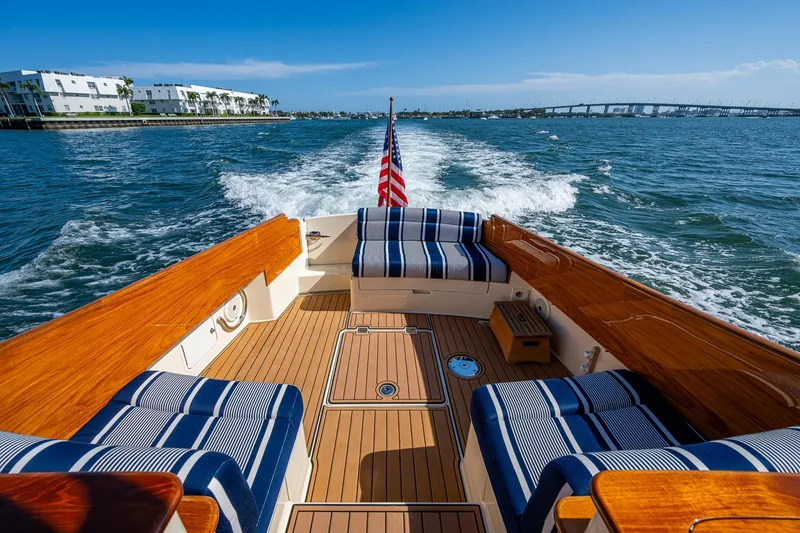 Gracious Yacht Photos Pics Hinckley Picnic Boat 37 MKIII, 2018, cruising on open water with elegant seating and American flag.