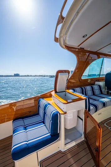 Gracious Yacht Photos Pics 2018 Hinckley Picnic Boat 37 MKIII with striped seating, cruising on sunny waters.