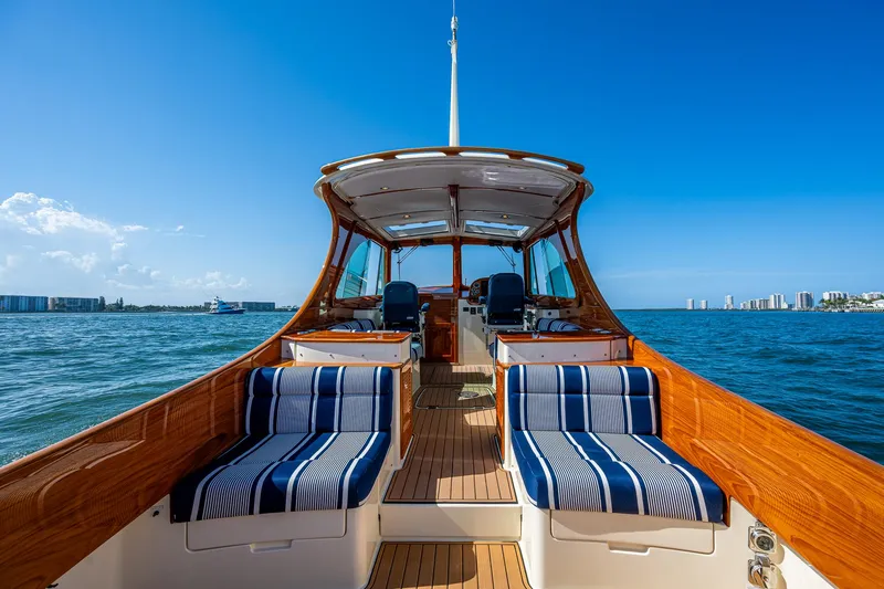Gracious Yacht Photos Pics 2018 Hinckley Picnic Boat 37 MKIII on water, featuring elegant seating and wooden finishes.