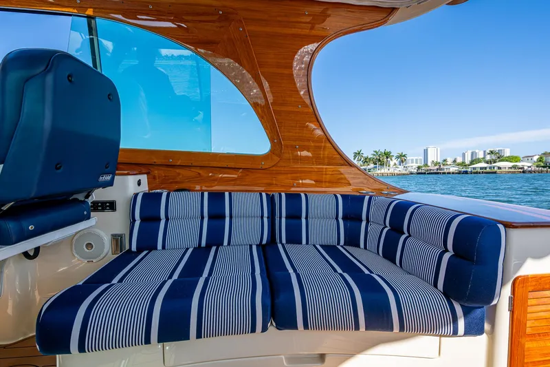 Gracious Yacht Photos Pics 2018 Hinckley Picnic Boat 37 MKIII interior with striped seating and wooden accents.